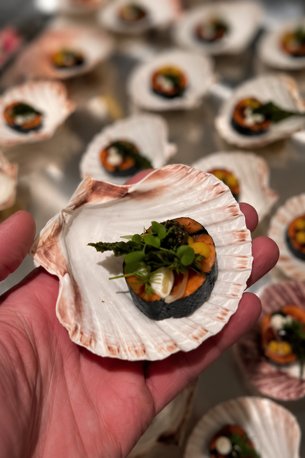 Scallop shell canapé with caviar and micro herbs