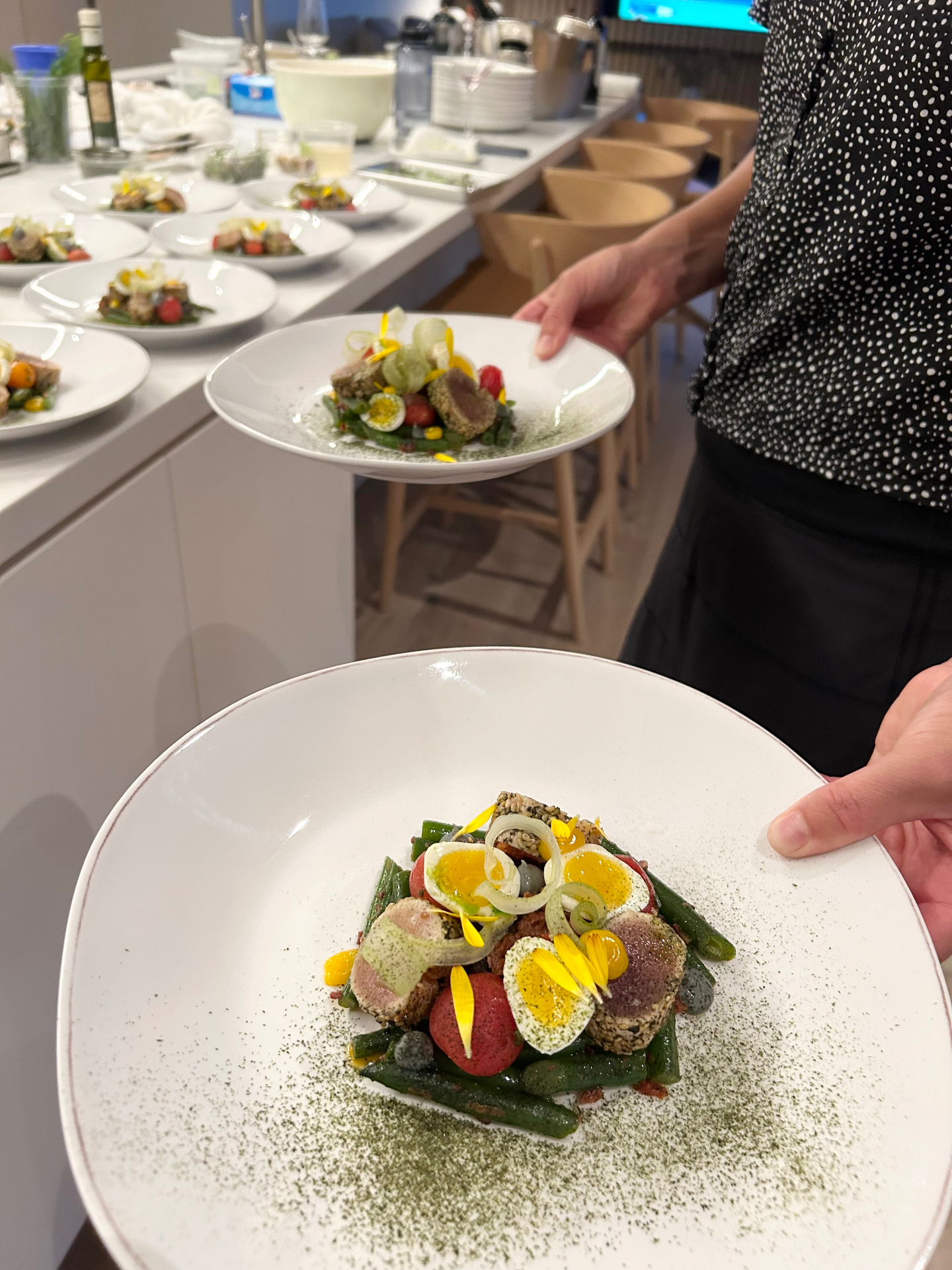 Server presenting a plated course tableside