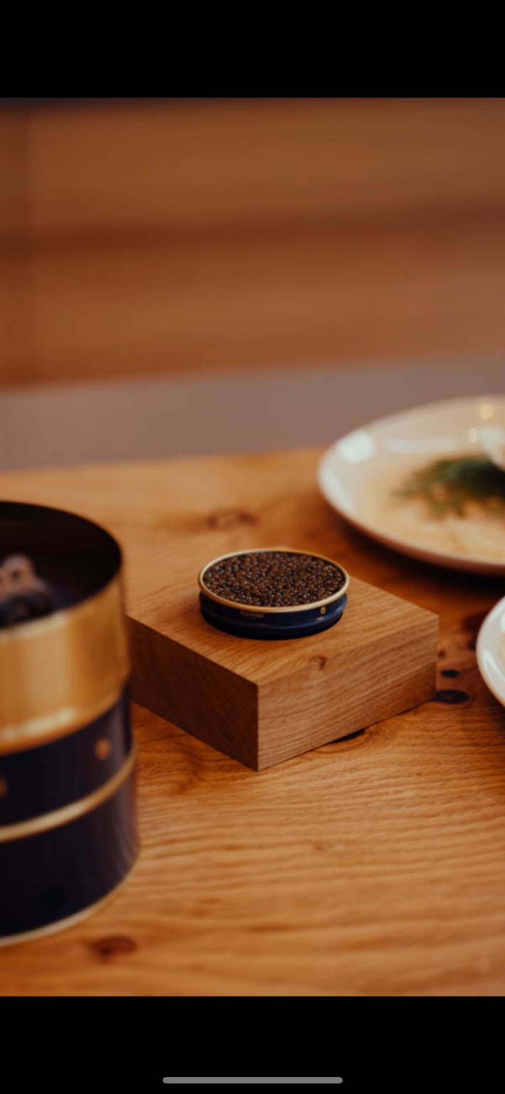 Tin of caviar set on a wooden block for a private dinner