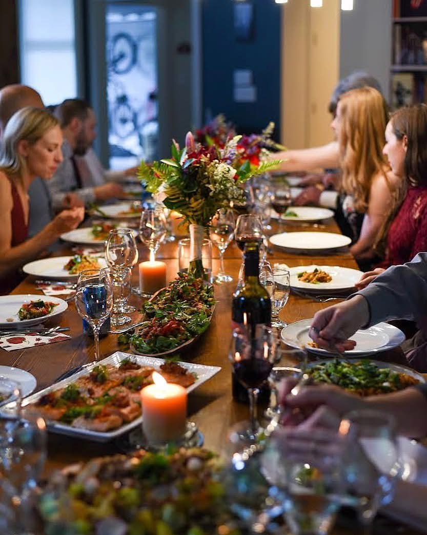 Guests seated around a beautifully set table for a private dinner