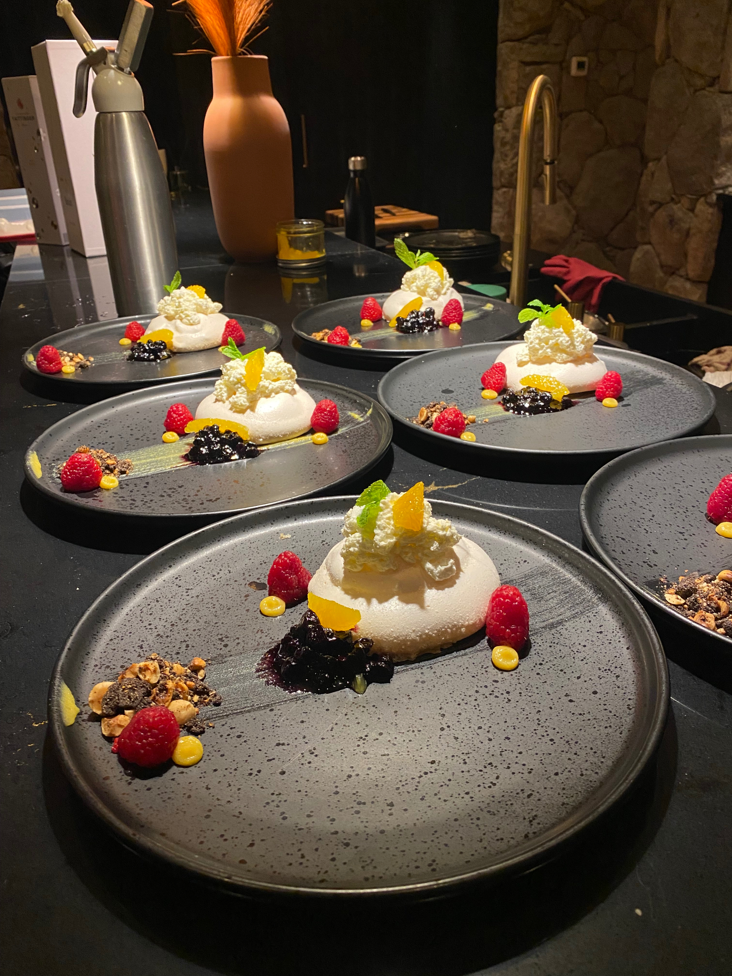 Individual pavlovas with berries, citrus and hazelnut crumble
